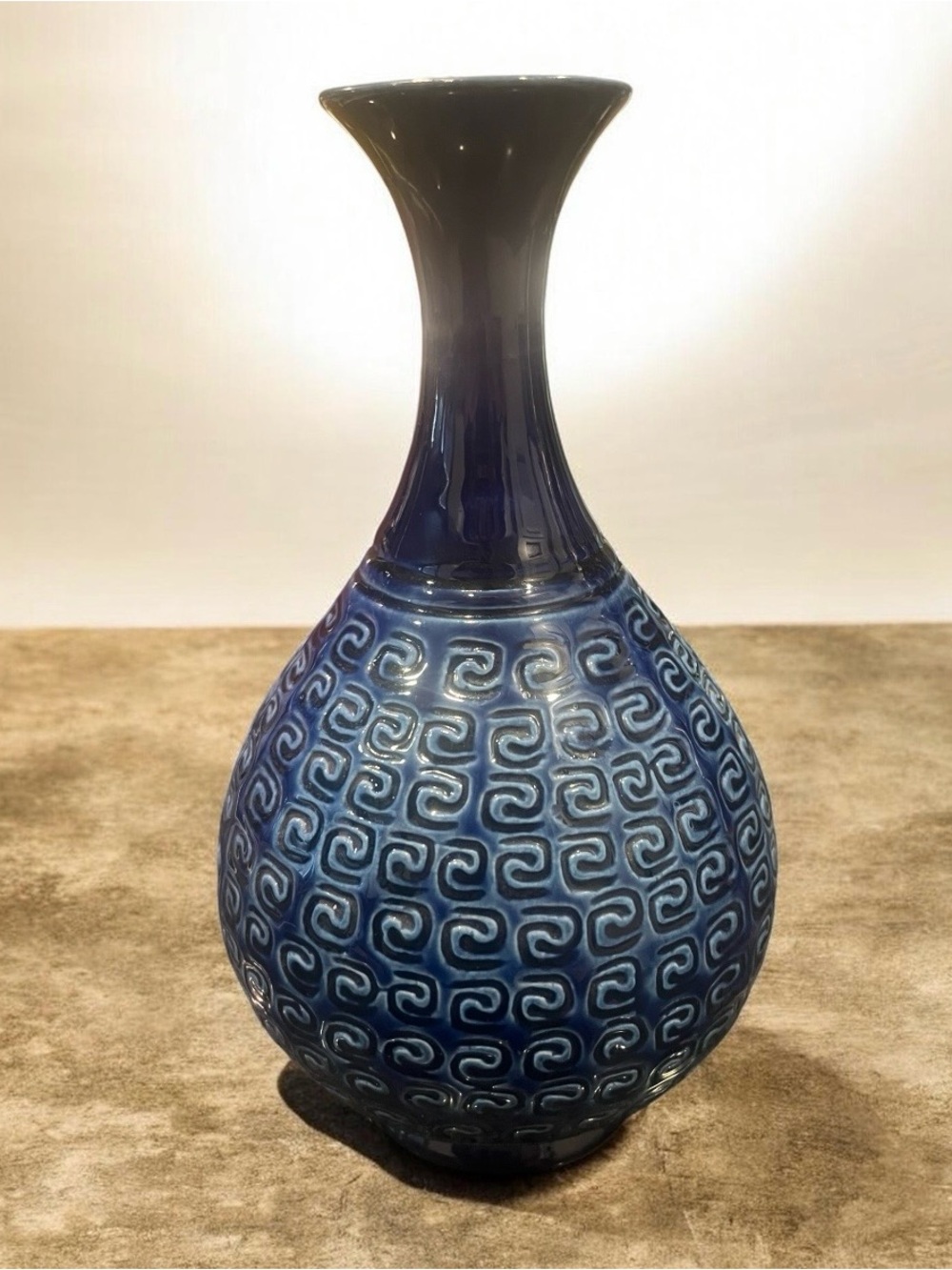 Vintage 1960s Hyalyn USA cobalt blue vase with raised karakusa scroll pattern.